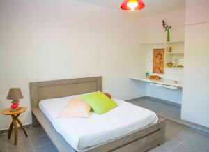 a bedroom with a bed with white sheets and a table at Villa Joland in Sainte-Anne +45 photos