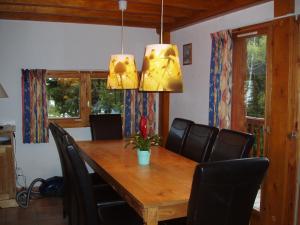 a dining room with a wooden table and black chairs at Chalet in Huez near Ski Slope in Oz