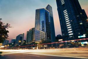 a city skyline with tall buildings at night at Pan Pacific Xiamen(Near the Ferry to Gulang Island and Metro Station) in Xiamen