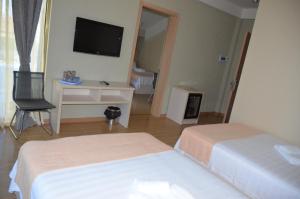 Postelja oz. postelje v sobi nastanitve Legacy Hotel
