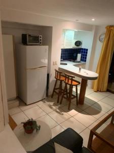 a kitchen with a white refrigerator and a table and chairs at Torre Condomar Beside Sunscape in Puerto Vallarta