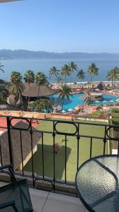 a view of a resort with a pool and palm trees at Torre Condomar Beside Sunscape in Puerto Vallarta +5 photos