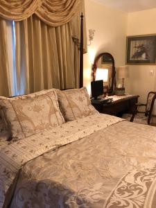 a bedroom with a bed with a desk and a mirror at Angies B&B in Wilmington