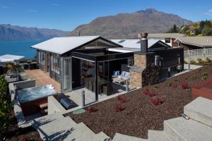 an aerial view of a house with a view of the water at Mountain Vista - beautifully renovated home with spa pool in Queenstown