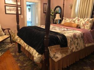 a bedroom with a large bed with a canopy at Angies B&B in Wilmington
