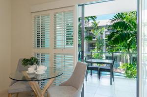 a dining room with a glass table and chairs at Shantara Resort Port Douglas - Adults Only Retreat in Port Douglas