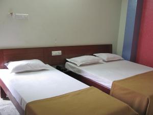 A bed or beds in a room at Hotel VIP Residency