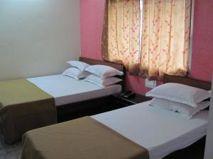 A bed or beds in a room at Hotel VIP Residency