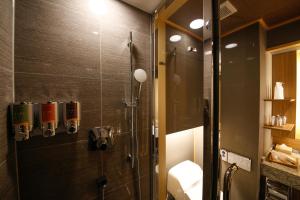 a shower with a glass door in a bathroom at The Shiroyama Terrace Tsuyama Villa in Tuyama