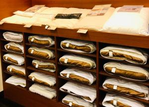 a closet filled with lots of hot dogs and towels at Kadoya Hotel in Tokyo