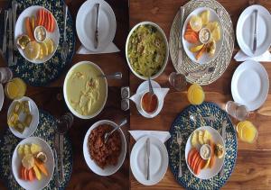 a wooden table with plates of food on it at C Beyond Nilaveli in Nilaveli
