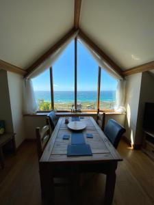 a dining room with a table and a view of the ocean at Beautiful Wales in Barmouth