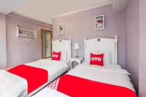 Säng eller sängar i ett rum på OYO 899 Villa De Hun