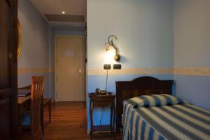 Postel nebo postele na pokoji v ubytování Hotel Belle Epoque