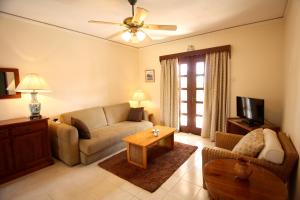 a living room with a couch and a tv at Maria Villa in Pissouri