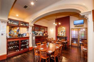 a dining room with a table and chairs at Tanunda Hotel Apartments in Tanunda