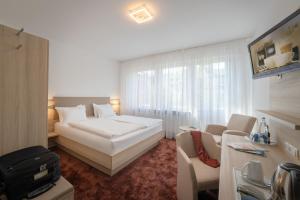 Postel nebo postele na pokoji v ubytování Hotel Brenner