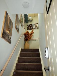 a hallway with stairs with a vase on the wall at Blacksmiths in Dartmouth