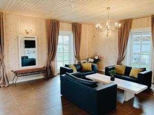 a living room with couches and a table at Vila Bianca in Inturkė