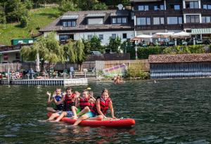people on a raft in the water at Landhotel Grünberg am See in Gmunden