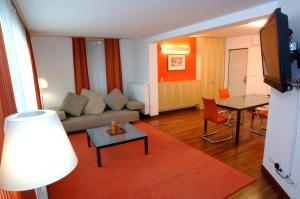 a living room with a couch and a table at Hotel Creina in Kranj