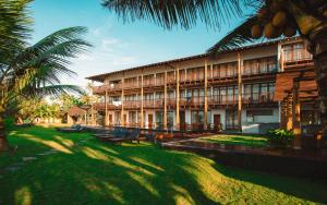 a building with palm trees in front of it at Timeless villa in Ahangama