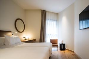 Łóżko lub łóżka w pokoju w obiekcie Hotel Arbaso