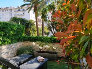 a cat sleeping on a bench in a garden at Hôtel de Provence in Cannes