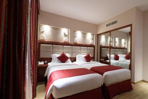 Giường trong phòng chung tại Al Liwan Suites Rawdat Al Khail