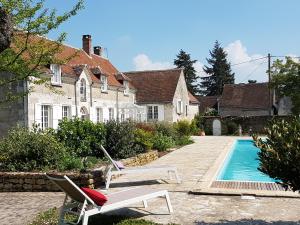 a house with a swimming pool in front of a house at la blanchetière in Francueil