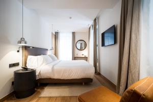 Łóżko lub łóżka w pokoju w obiekcie Hotel Arbaso