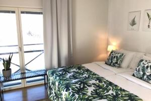 a bedroom with a bed and a large window at Casa Verde nearby Helsinki airport in Vantaa