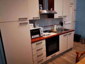 a kitchen with a white refrigerator and a microwave at Casa Cupiello Via Chiaia - Casa Vacanze ad uso Esclusivo in Naples