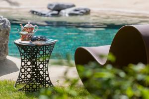 a table with a tea pot and glasses on it at Chalet Croq'Neige in Morzine