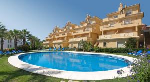 a large apartment building with a large swimming pool at Apartamentos Vista Real in La Alcaidesa