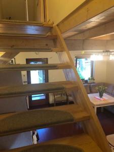 a staircase in a tiny house with a living room at Wooden House&Pool in Osowa +27 photos