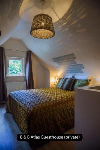 a bedroom with a bed and a ceiling at Atlas Private Guesthouse in Bruges