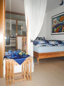 a bedroom with two beds and a table with blue dishes on it at Ferienwohnung Ilka Plank in Füssen