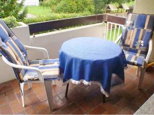 a blue table and two chairs on a patio at Ferienwohnung Ilka Plank in Füssen