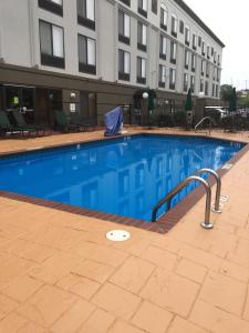 a large swimming pool in front of a building at Wingate by Wyndham Little Rock in Little Rock