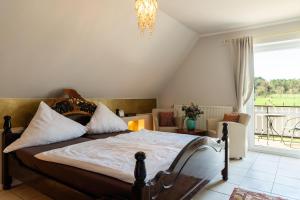 a bedroom with a bed and a large window at Landhaus Calluna in Undeloh