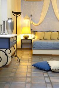 a bedroom with a bed and a table with a lamp at Atlantis Beach Villa in Perivolos