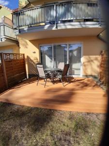 a patio with chairs and a table on a deck at Wohnung Bernstein - Nr. 4 in Dierhagen