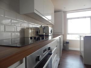 a kitchen with a counter top with a microwave at Harcourt Place in Scarborough