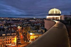 a view of a city at night from a building at Don Giovanni Hotel Prague - Great Hotels of The World in Prague +37 photos