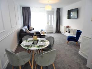 a living room with a table and chairs at Black Cart House in Johnstone