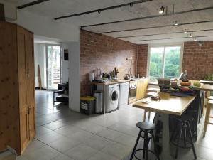 a kitchen with a washer and dryer at Vogüé meublé 2 étoiles, La plus belle vue de Vogüé in Vogüé