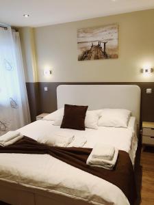 um quarto com uma cama grande e lençóis brancos em Glashütten Hotel em Glashütten
