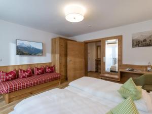 a living room with two beds and a couch at Apartmenthaus Katharina in Mayrhofen