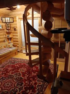 a wooden staircase in a room with a rug at Дом с баней на берегу озера in Ferapontovo